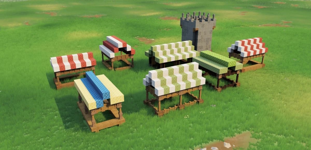Medieval voxel market with striped stalls beside a stone watchtower in a green meadow